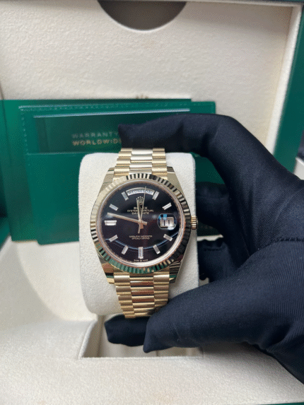 Super Clone Rolex Day-Date 228238 replica with yellow gold case, onyx black dial, fluted bezel, and President bracelet