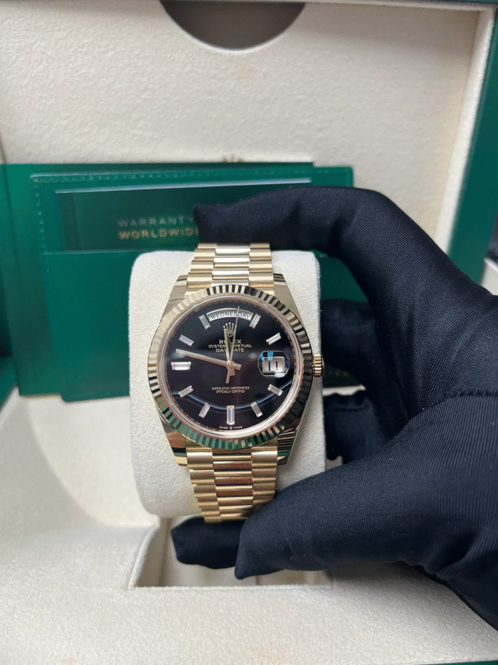 Super Clone Rolex Day-Date 228238 replica with yellow gold case, onyx black dial, fluted bezel, and President bracelet